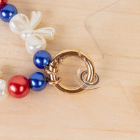 Load image into Gallery viewer, 70974 - USA Beaded Bow Phone Wristlet - Red White &amp; Blue
