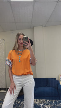 Load and play video in Gallery viewer, 30012 - Orange Top with Geometric Balloon Sleeves

